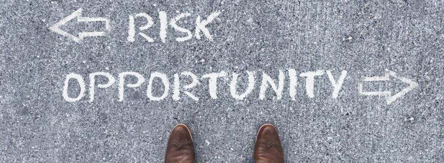 Top view on a man standing in front of the words "Risk" and "Opportunity" with arrows pointing to the left and right side of the picture