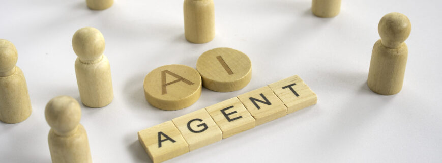 AI Agent text on wooden blocks with human figures representing artificial intelligence automation and digital workforce concept.